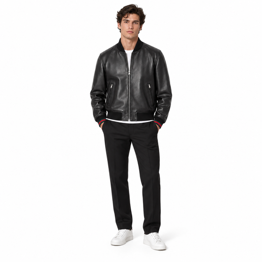 Man wearing black leather bomber jacket with red-tipped trim and white sneakers