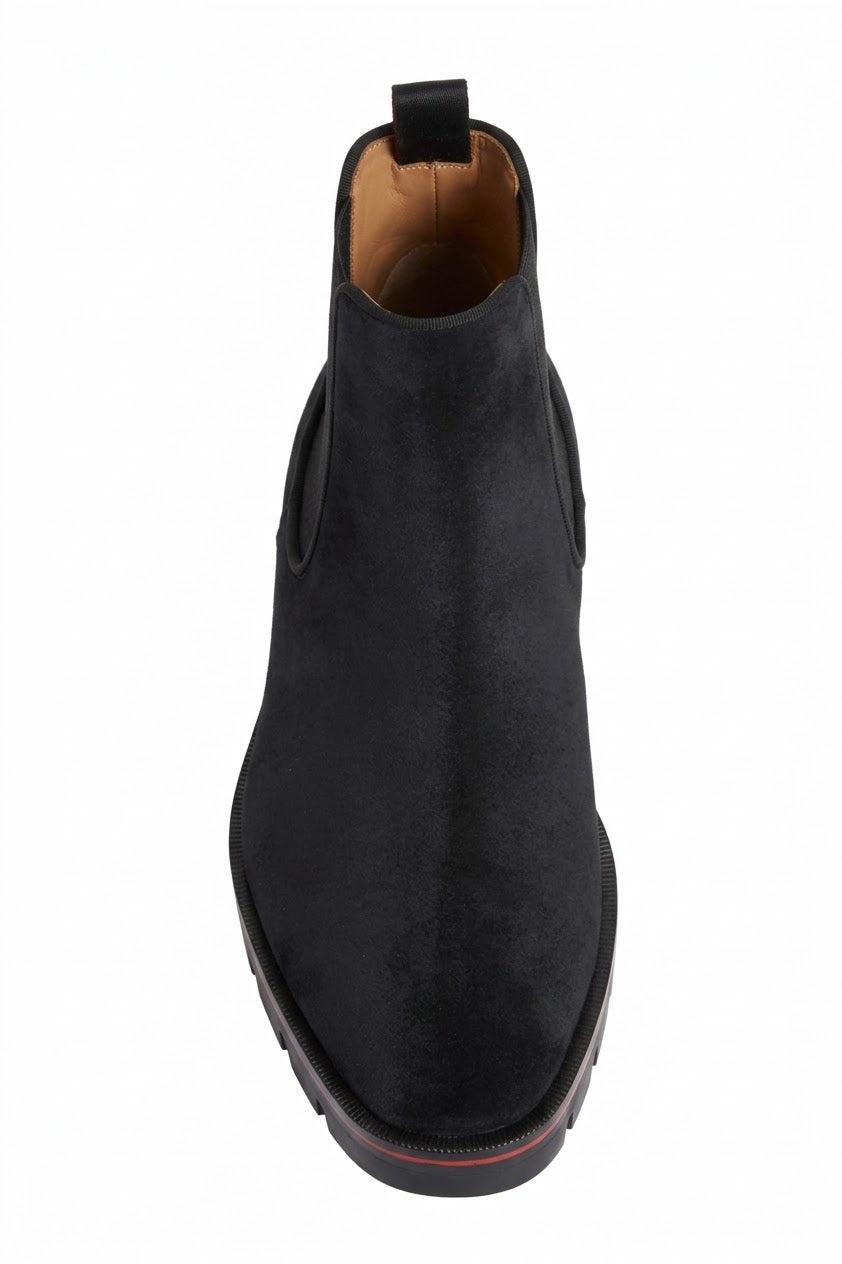 Back view of black suede Chelsea boot with pull tab