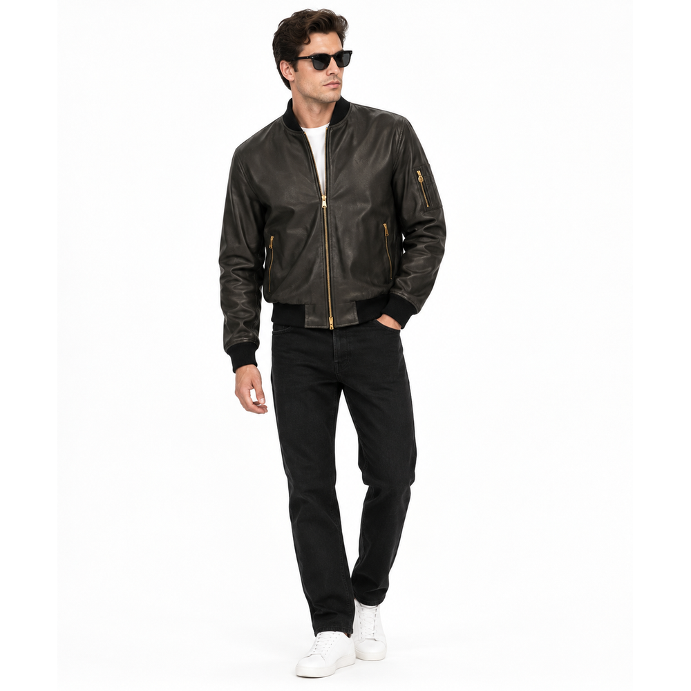 Man wearing a black leather MA-1 bomber jacket with black jeans