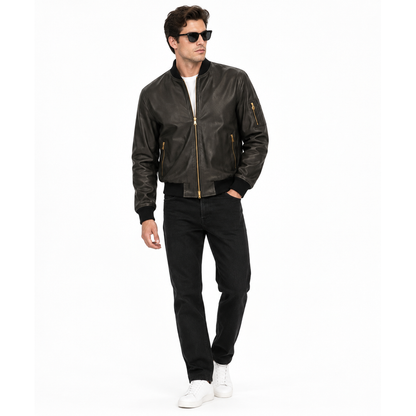 Man wearing a black leather MA-1 bomber jacket with black jeans
