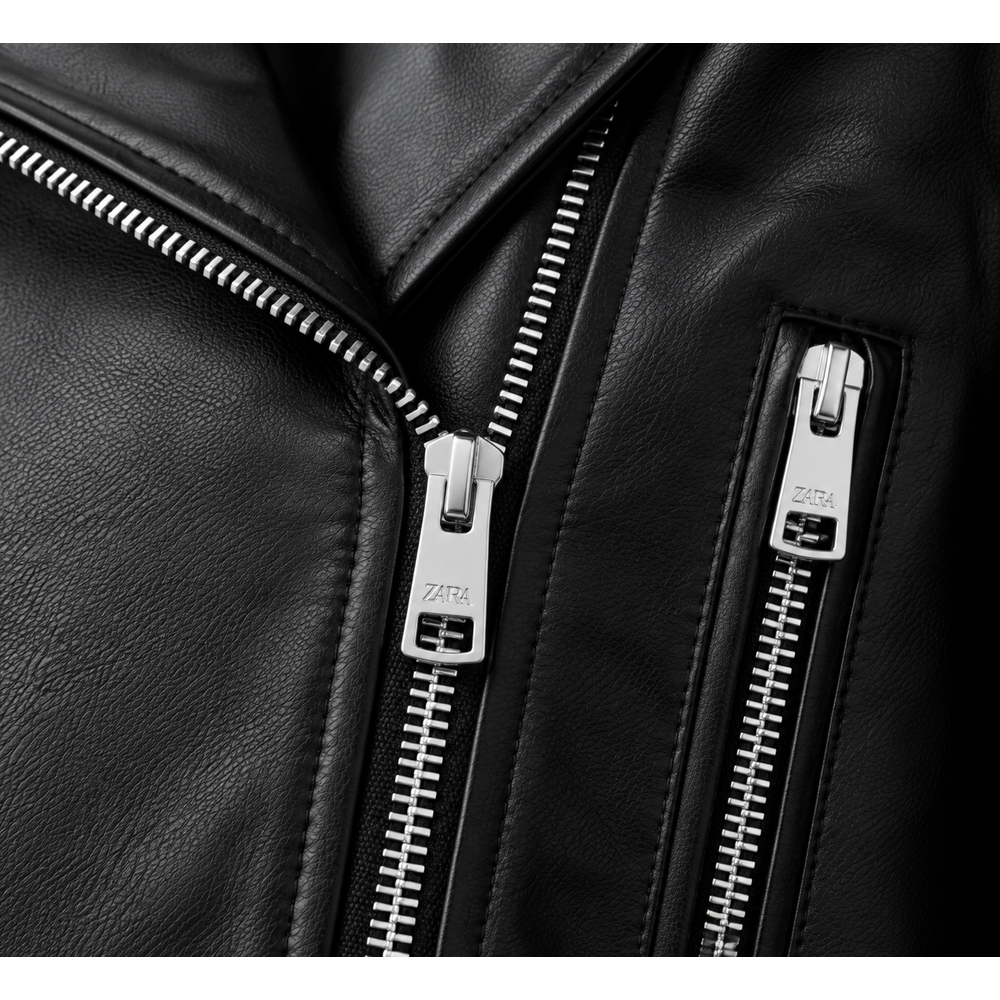 Close-up of asymmetric zip and zip pocket on black leather jacket