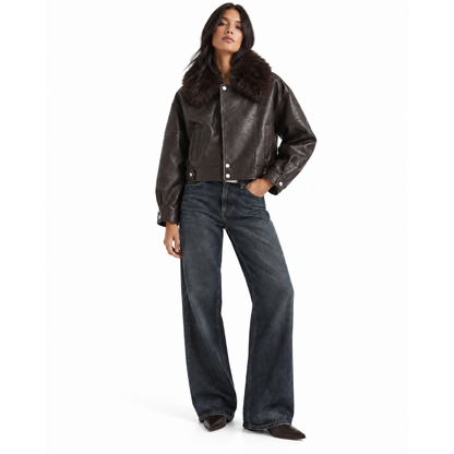 Model wearing women's brown leather aviator jacket with wide-leg jeans