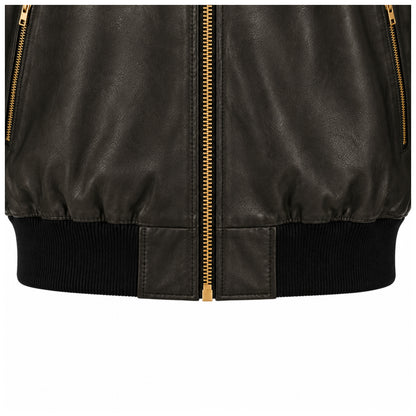 Close-up of gold zip pockets and ribbed waistband on black leather bomber