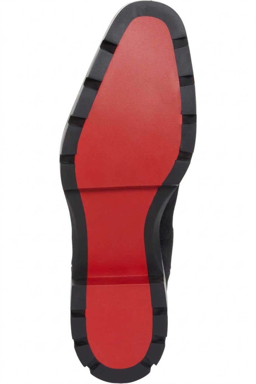 Red lug outsole of men's black suede Chelsea boot