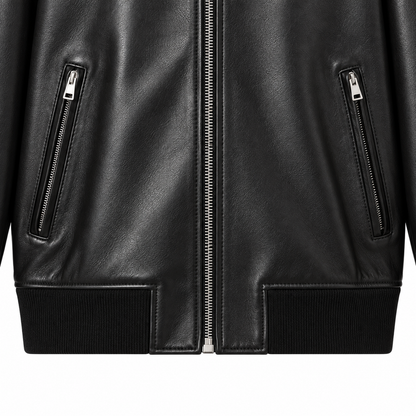 Close-up of zip pockets and ribbed waistband on black leather bomber jacket