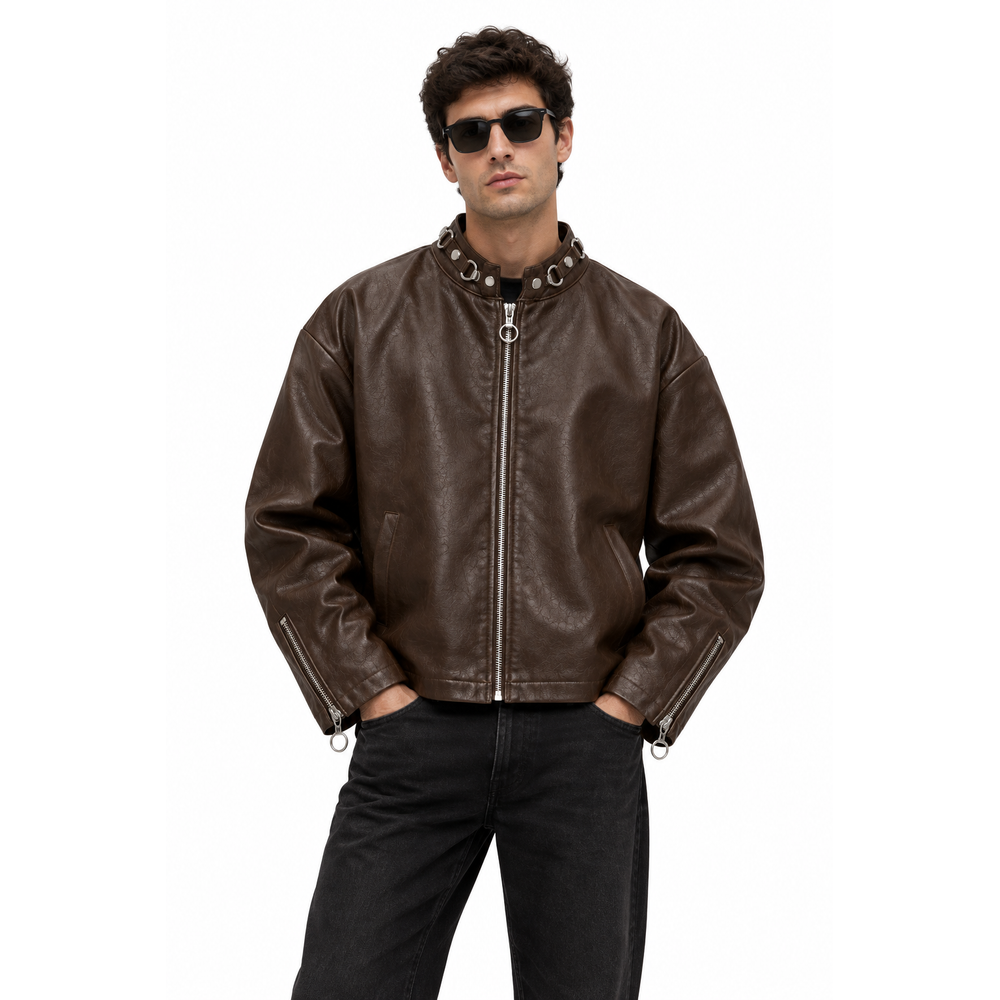 Man wearing a dark brown leather moto jacket with sunglasses and black jeans