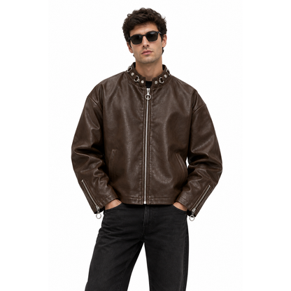 Man wearing a dark brown leather moto jacket with sunglasses and black jeans