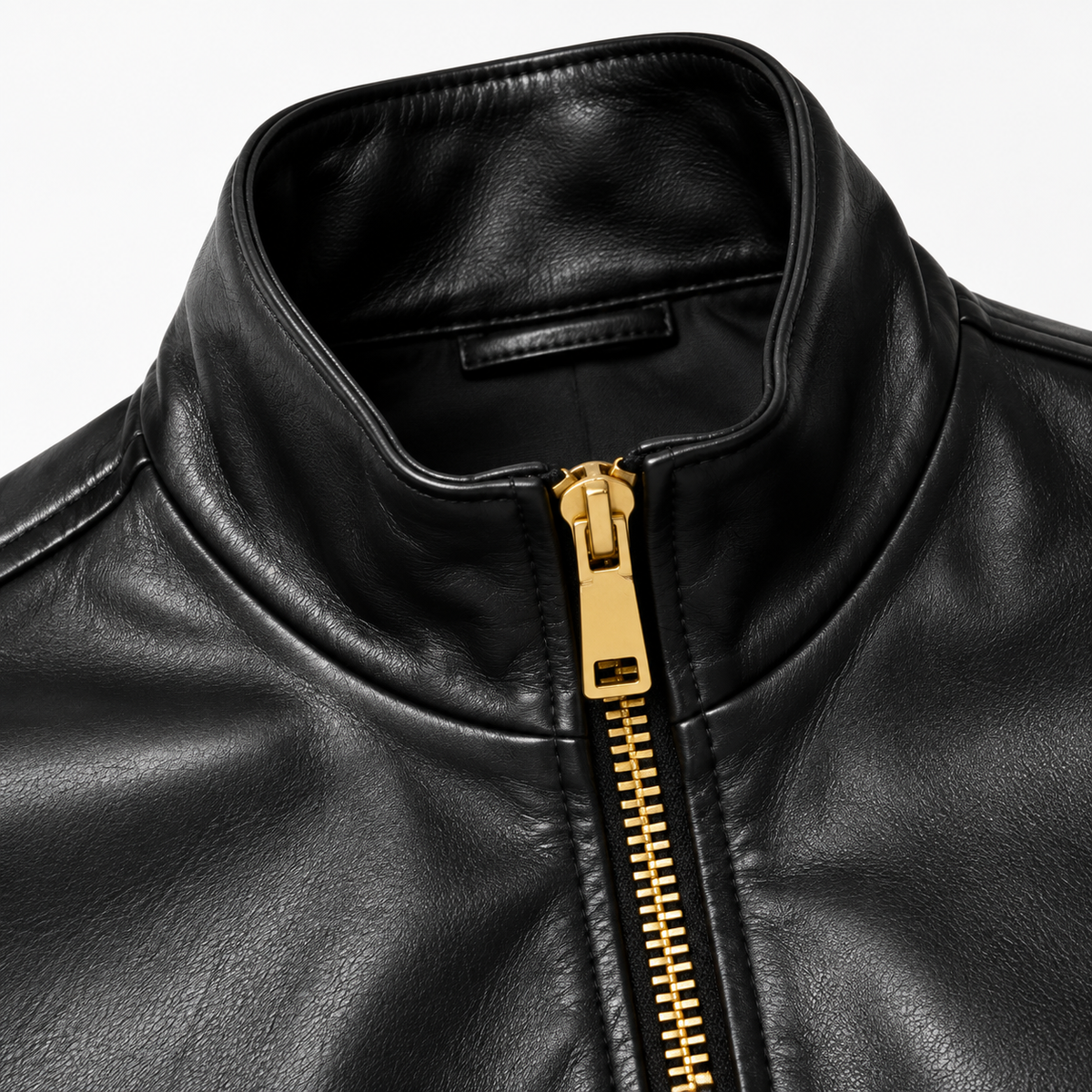 Close-up of stand collar and chunky gold zip on black leather jacket