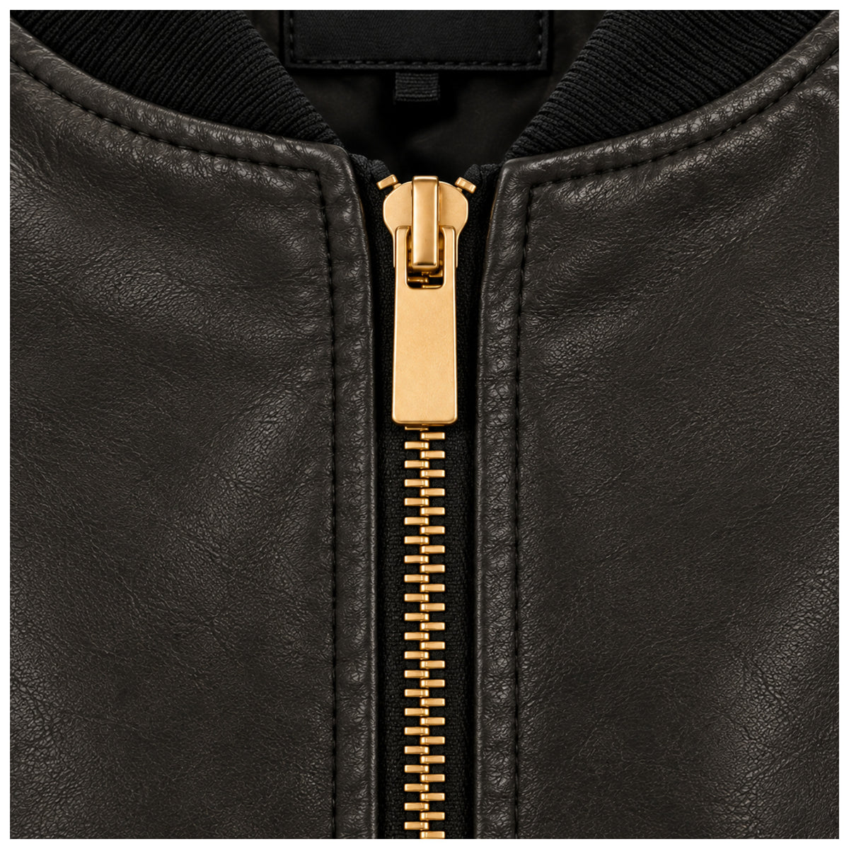 Close-up of gold-tone front zip on black leather MA-1 jacket