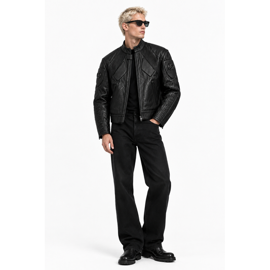 Man wearing black embossed leather moto jacket with black trousers