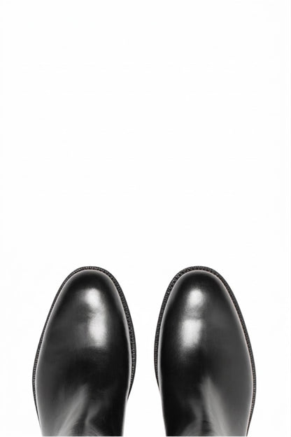 Top view of pair of black leather Chelsea boots