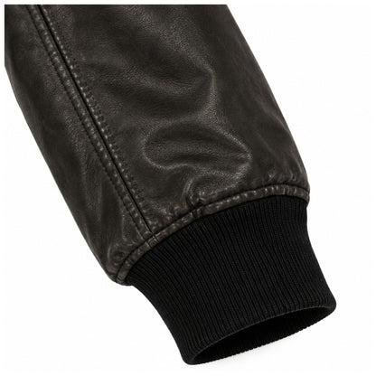 Close-up of ribbed cuff on men's black leather bomber jacket sleeve