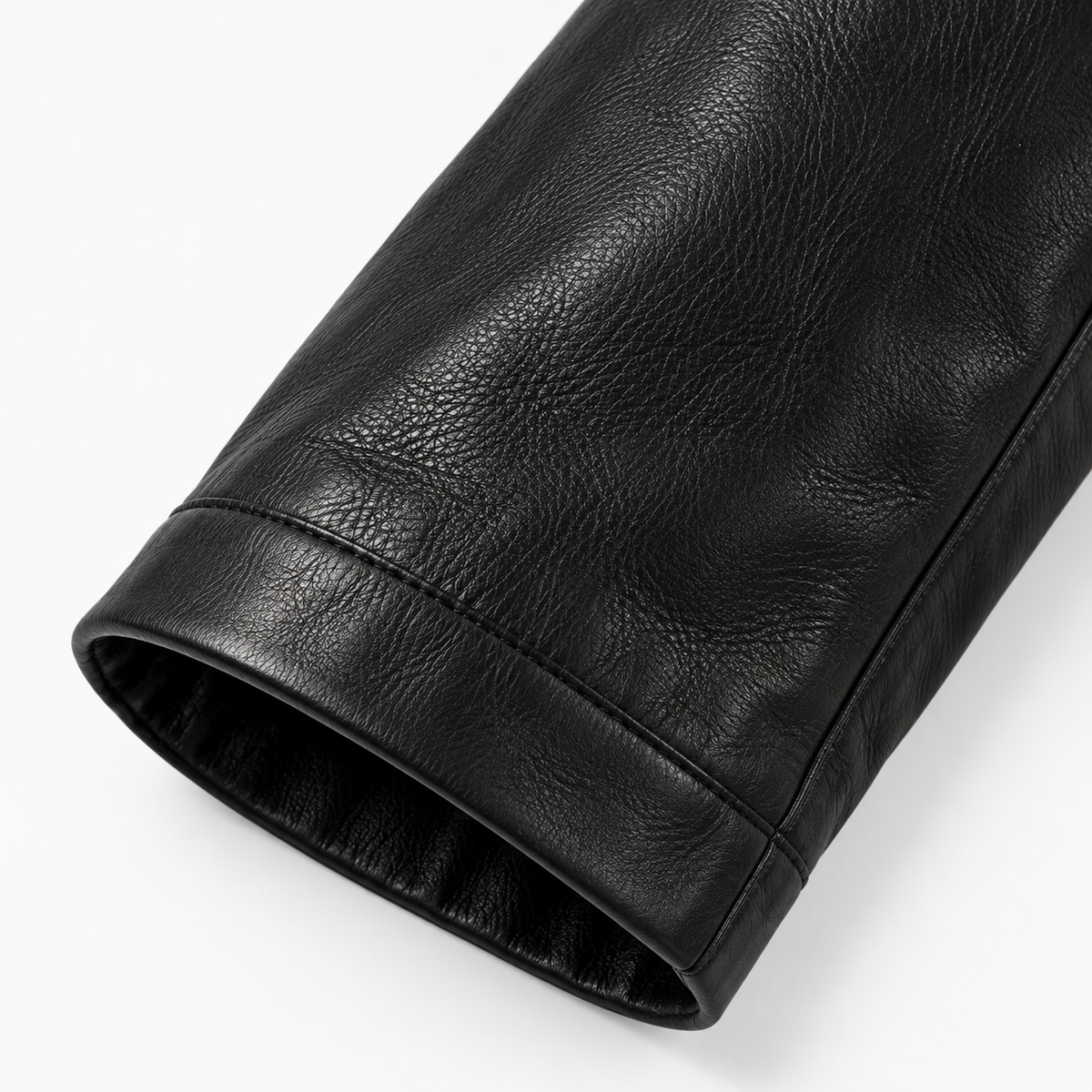 Close-up of ribbed cuff on men's black leather bomber jacket