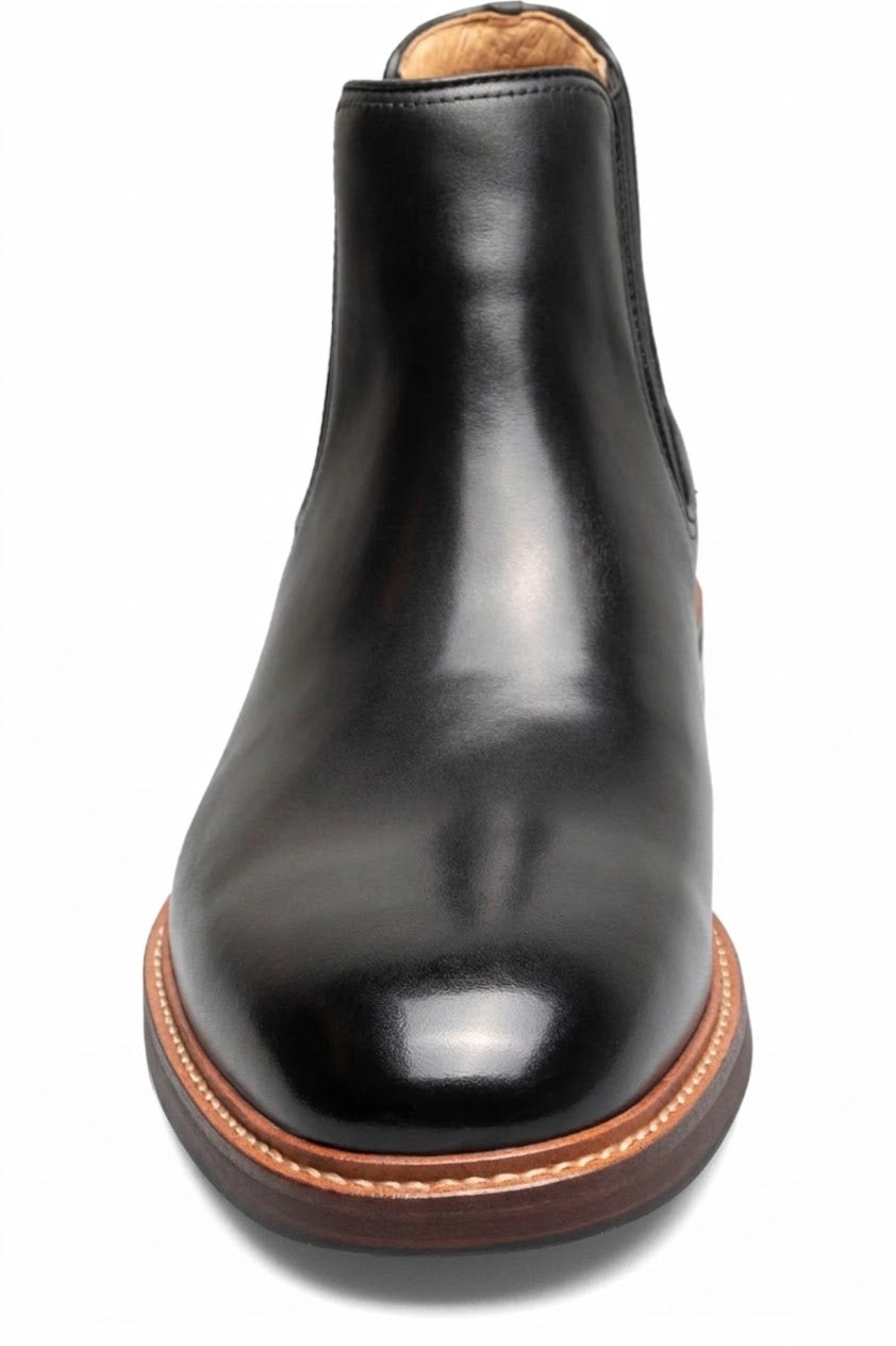 Front view of black leather Chelsea boot with brown welt