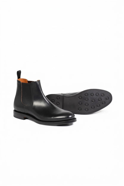 Black leather Chelsea boot side view with sole detail