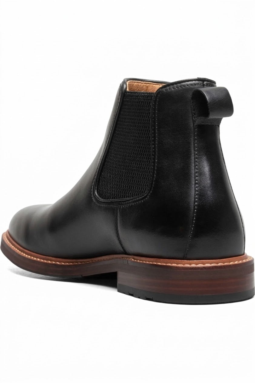 Three-quarter view of black Chelsea boot with brown sole