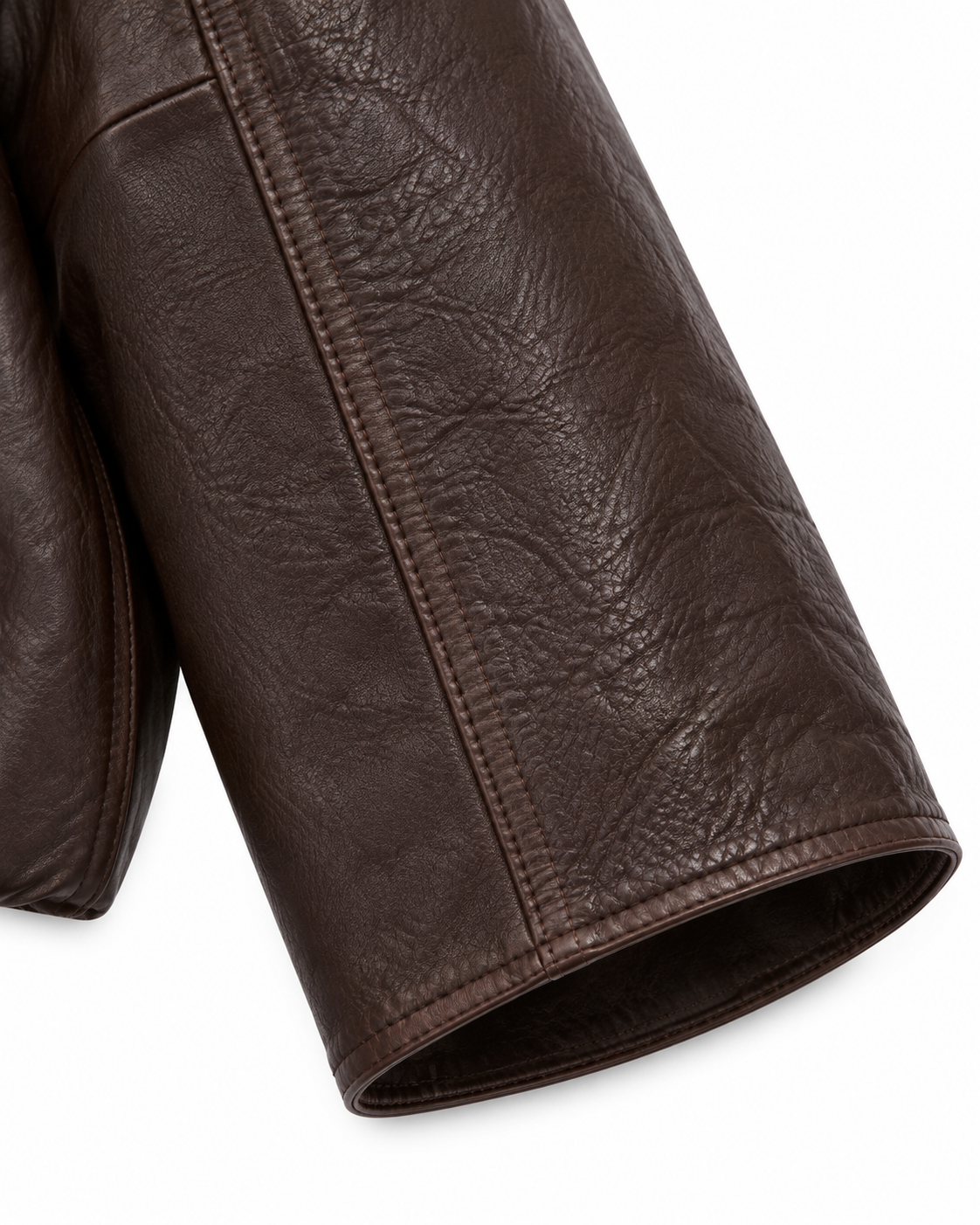 Close-up of sleeve and cuff on women's brown leather jacket